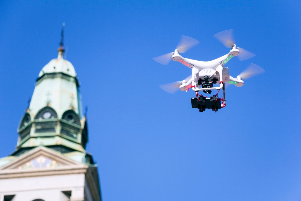 dron lecący nad katedrą na tle niebieskiego nieba
